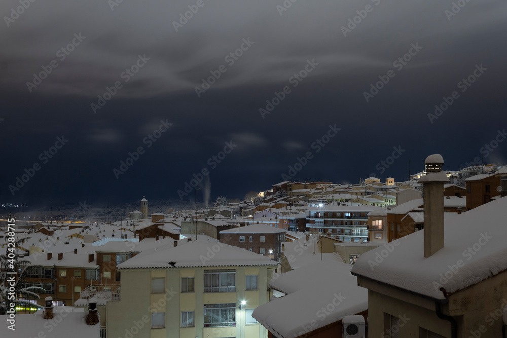 Snowed roofs at night, after a blizzard