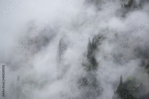 Mist in the mountains of the Bavarian alps near Garmisch Partenkirchen with some barely visible trees no. 3