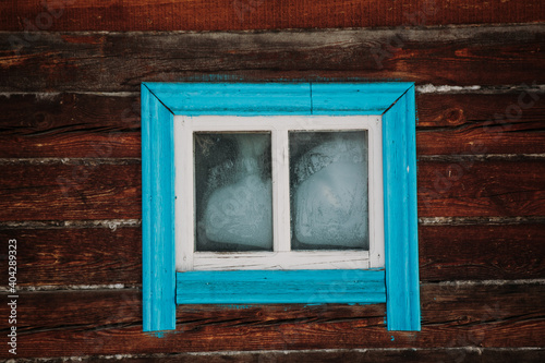 Window in an old wooden house view from the street