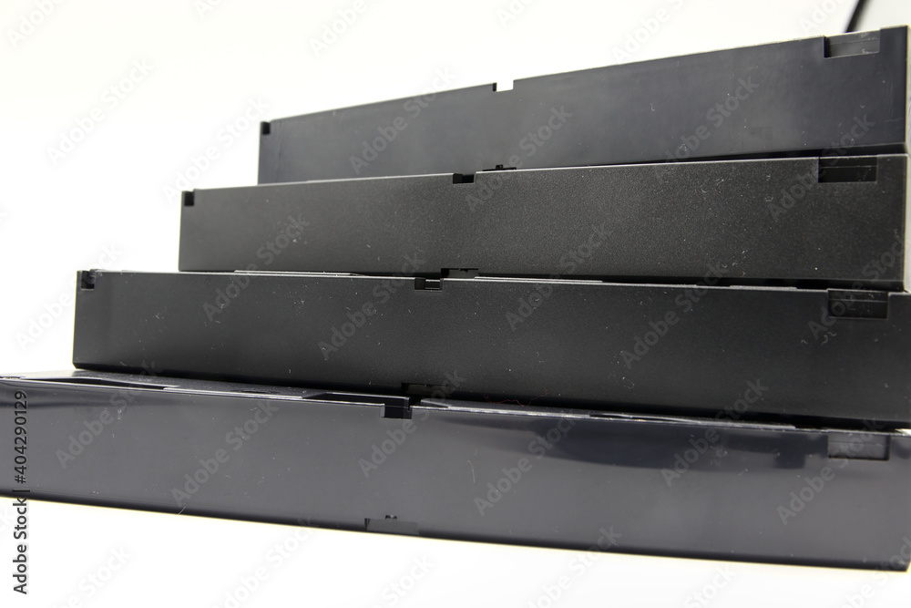 In the foreground a staircase made from old VHS. In the 80s they were used for watching movies, through the internal film. In the foreground a staircase made from old VHS. In the 80s they were used for watching movies, through the internal film.