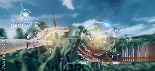 smart agriculture futuristic industry 4.0 technology concept, cyborg hand put to touch hand with green leaves with hud technology including artificial intelligence, 5g to analysis data of smart farm