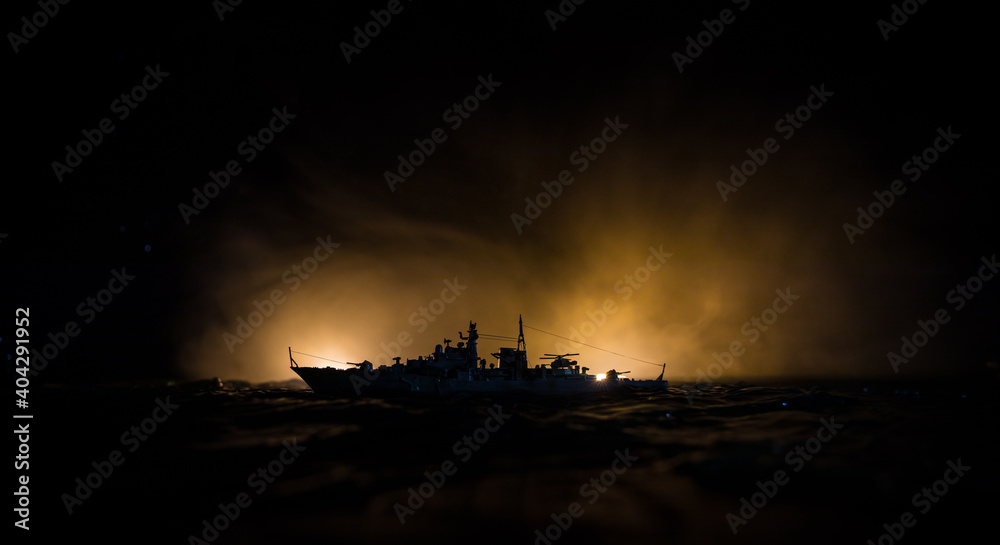 Silhouettes of a crowd standing at blurred military war ship on foggy background. Selective focus. Passengers try to escape. Protest of people