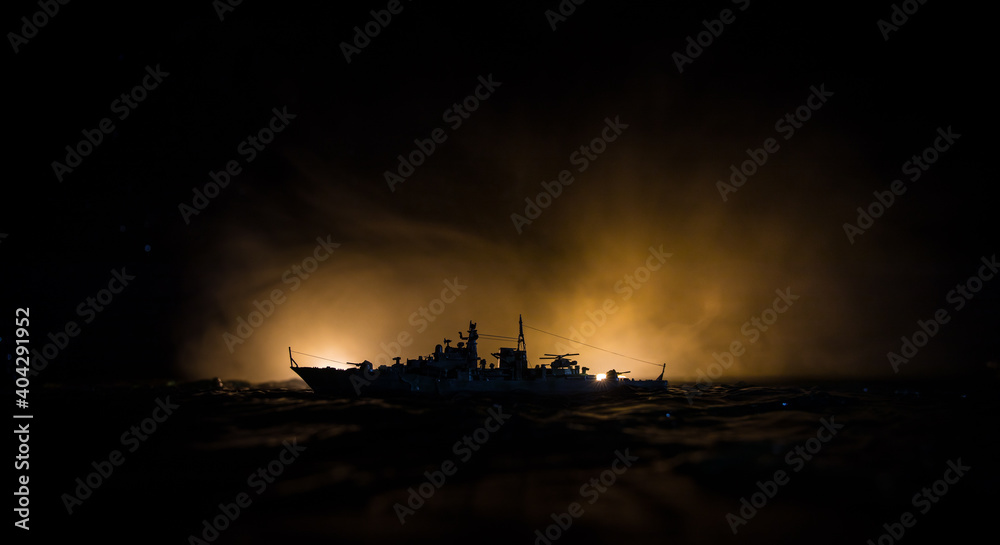 Fototapeta premium Silhouettes of a crowd standing at blurred military war ship on foggy background. Selective focus. Passengers try to escape. Protest of people
