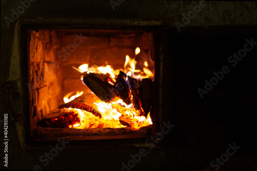 Fire in the stove, wood, sparks, on a black background