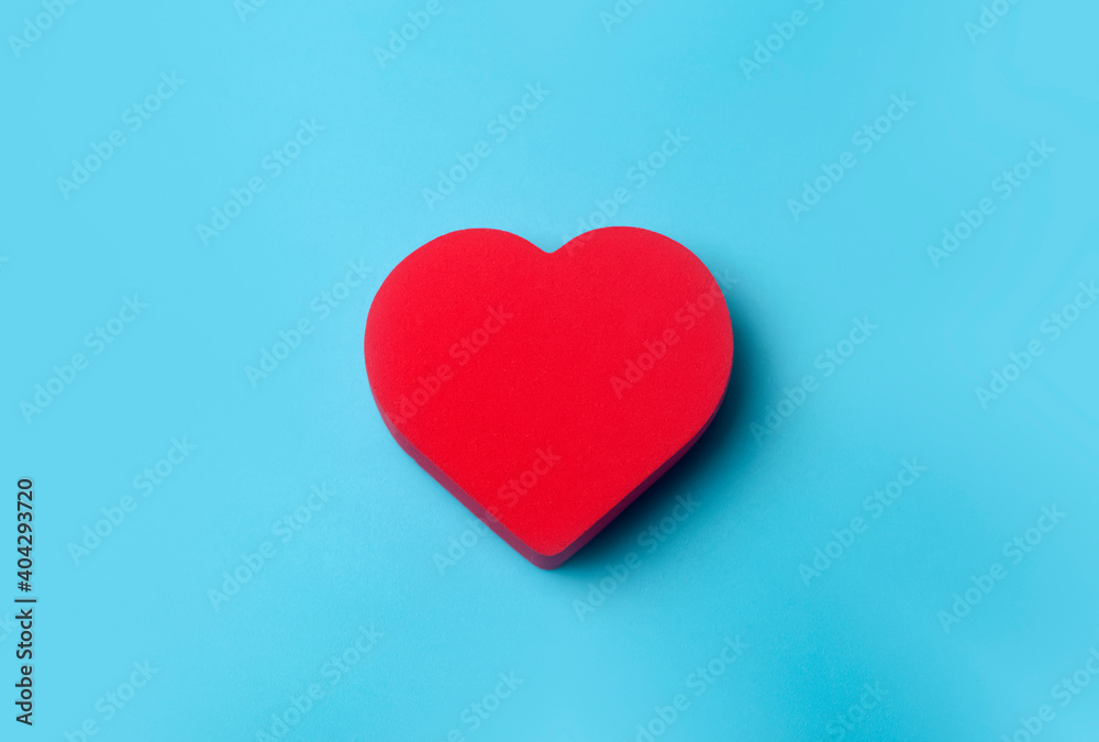 Valentine's day background. Red heart on a blue minimal background. Love, romance and heart concept. Valentine's day background. Red heart on a blue minimal background. Love, romance and heart concept.