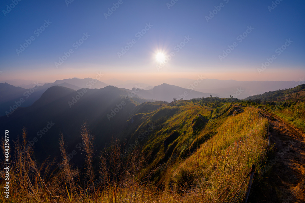 Beautiful natural landscape on the hilltop with winter sunset at Phu Chi Fa Viewpoint, Chiang Rai, Thailand.