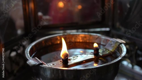 Woman burning incense from red candle prepare for pray the buddha , chinese gods and pay respect.