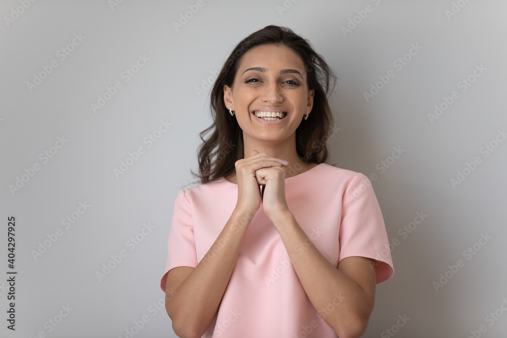 Headshot portrait of smiling Indian Arabic woman isolated on grey studio wall background posing. Profile picture of happy millennial middle eastern female feel excited overjoyed. Happiness concept. Headshot portrait of smiling Indian Arabic woman isolated on grey studio wall background posing. Profile picture of happy millennial middle eastern female feel excited overjoyed. Happiness concept.