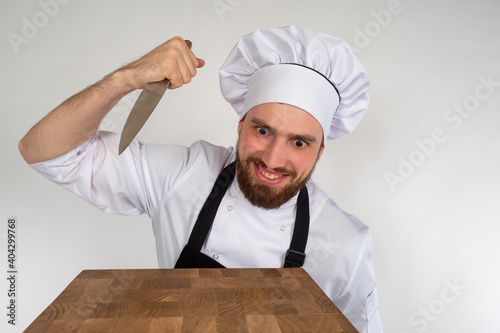 Aggressive chef with a knif...