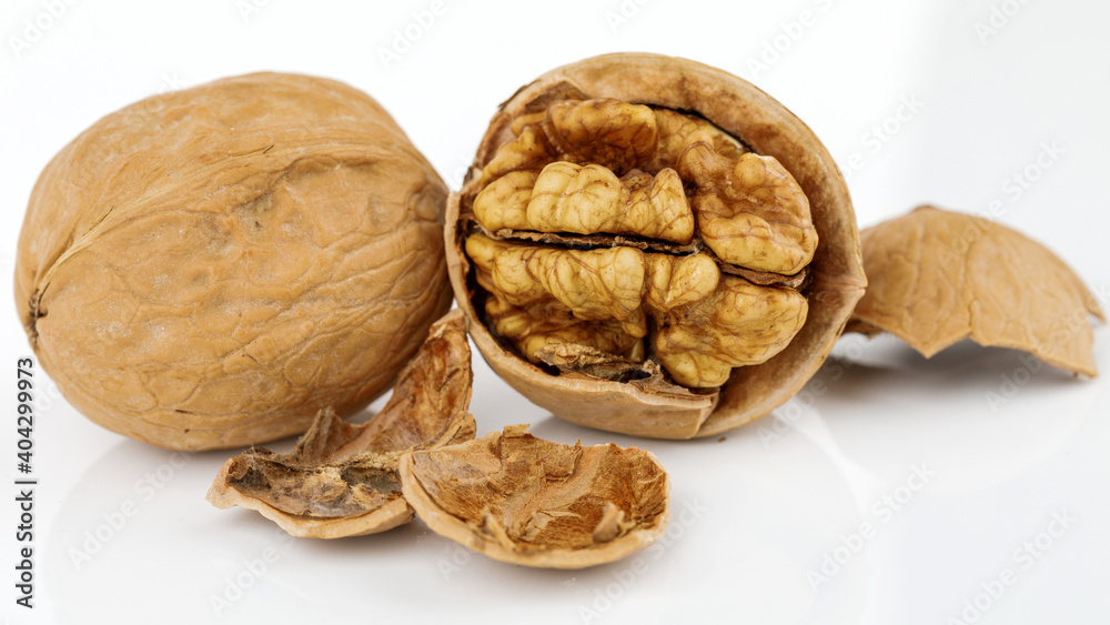 some cracked walnuts isolated on white background some cracked walnuts isolated on white background