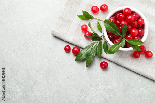 Flat lay composition with cranberry on light table, space for text