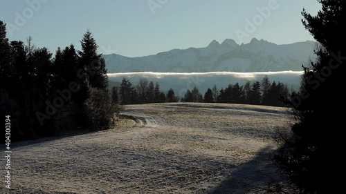 Timelapse of clouds between High Tatras and Spisska Magura mountains in windy winter day, Slovakia. Typical slovakian countryside of fields and meadows with Mala Frankova village in valley.
