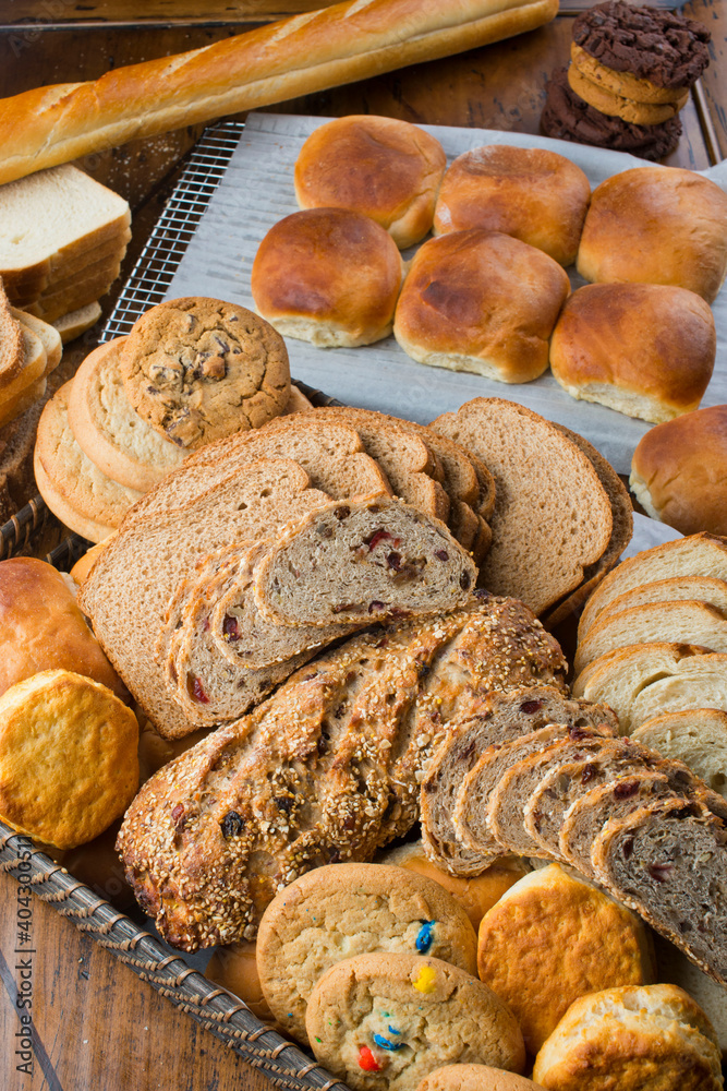 Bread. Bread, loafs, rolls, baguettes, bagels, slices of fresh homemade bread. Traditional classic bakery goods. Made from scratch in a bakery by a baker. 