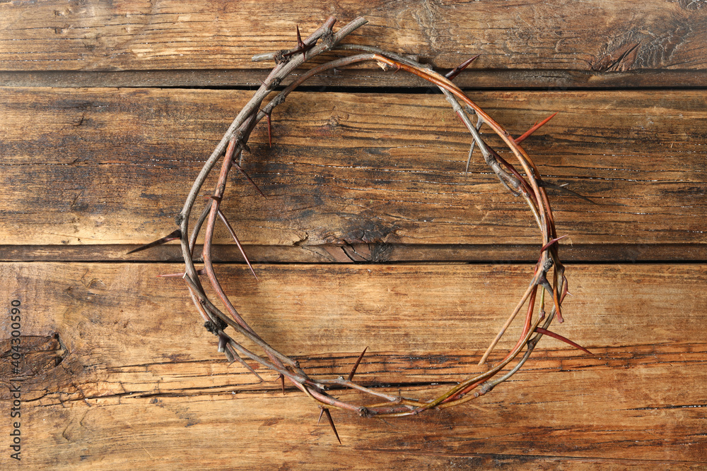 Crown of thorns on wooden background, top view. Easter attribute Crown of thorns on wooden background, top view. Easter attribute