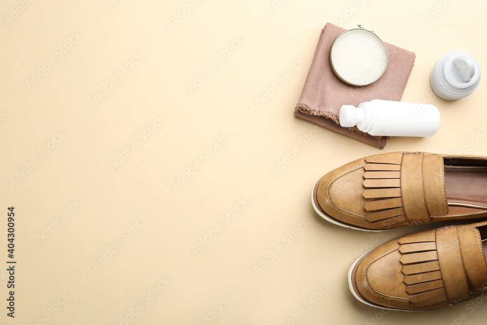 Obraz premium Flat lay composition with shoe care accessories and footwear on beige background. Space for text