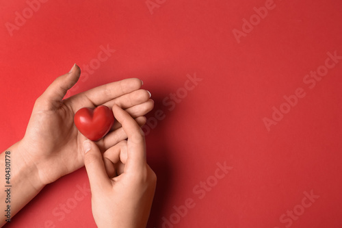 Woman holding decorative heart on red background  top view with space for text. Happy Valentine s Day