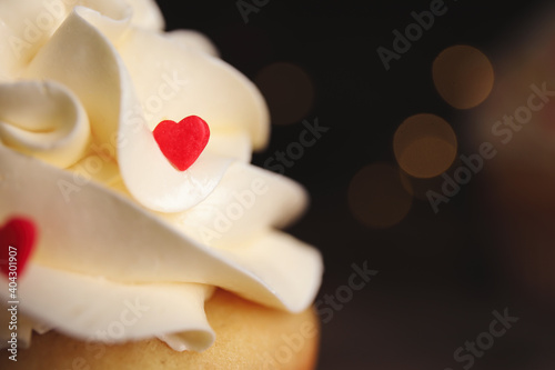Tasty sweet cupcake on blurred background  closeup view with space for text. Happy Valentine s Day