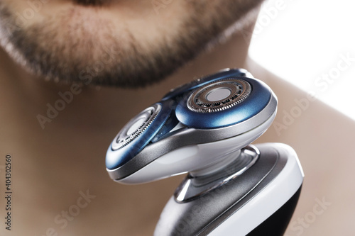 Male chin and modern electric shaver photo