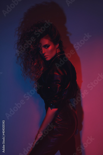 Young and sexy woman with a stylish Afro hairstyle wearing leather biker suit © blackday