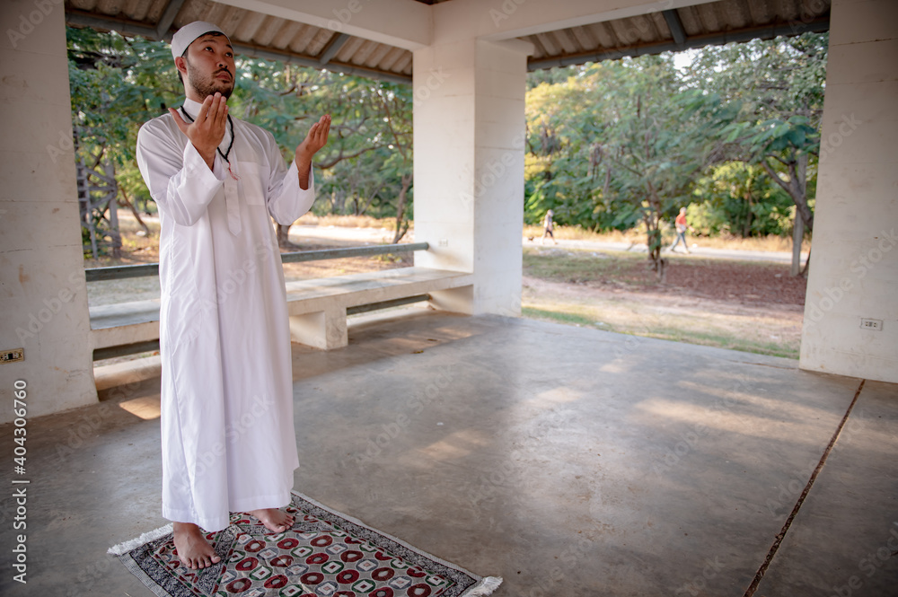 Fototapeta premium Asian islam man prayer,Young Muslim praying,Ramadan festival concept