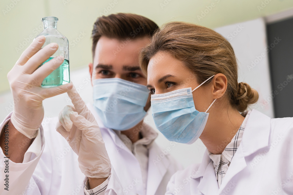 Scientist colleagues is working with a chemical reagents in a laboratory during research Scientist colleagues is working with a chemical reagents in a laboratory during research