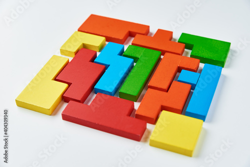 Logical thinking concept. Different shapes colorful wooden blocks on white background