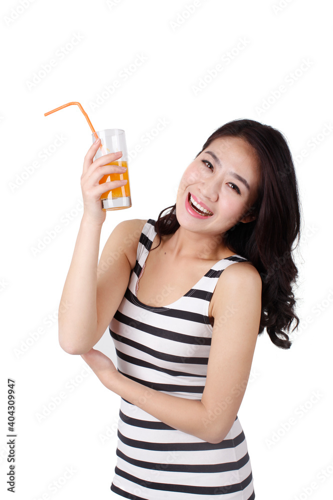 Young woman in a striped dress drinking a glass of orange juice Young woman in a striped dress drinking a glass of orange juice