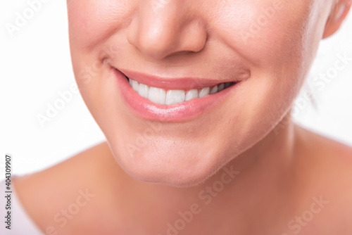 Female face with white teeth isolated on white background.