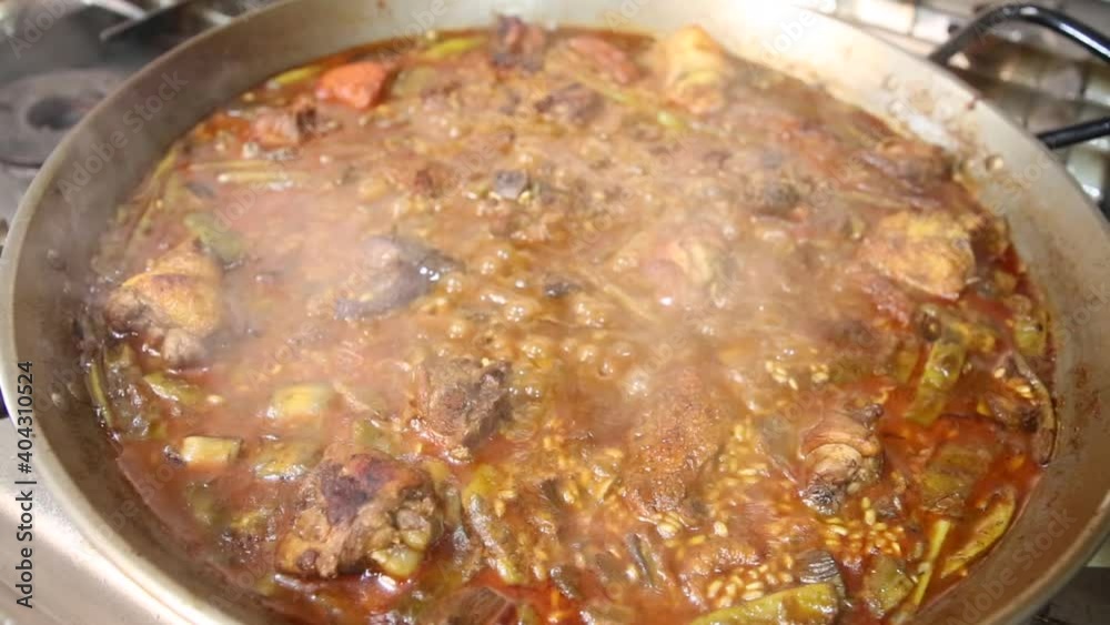 Rice with meat and vegetables. Authentic Valencian paella made with firewood. Making Valencian paella. How to make a paella. Meat paella with vegetables Rice with meat and vegetables. Authentic Valencian paella made with firewood. Making Valencian paella. How to make a paella. Meat paella with vegetables