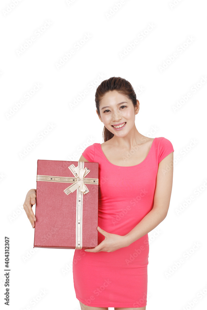 Young woman in pink dress holding gift box Young woman in pink dress holding gift box