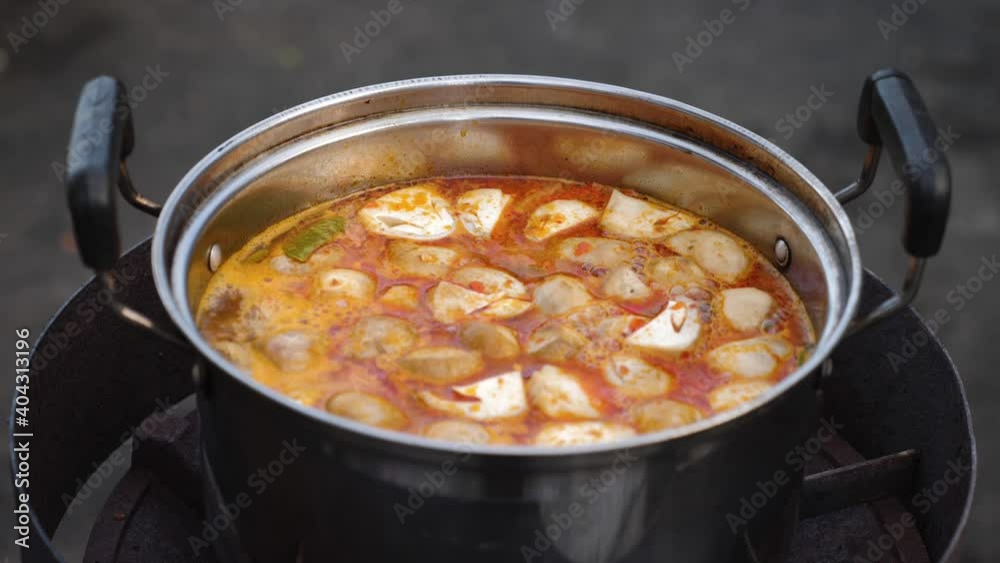Delicious pot of Tom Yum soup being prepared by thai woman. Delicious pot of Tom Yum soup being prepared by thai woman.