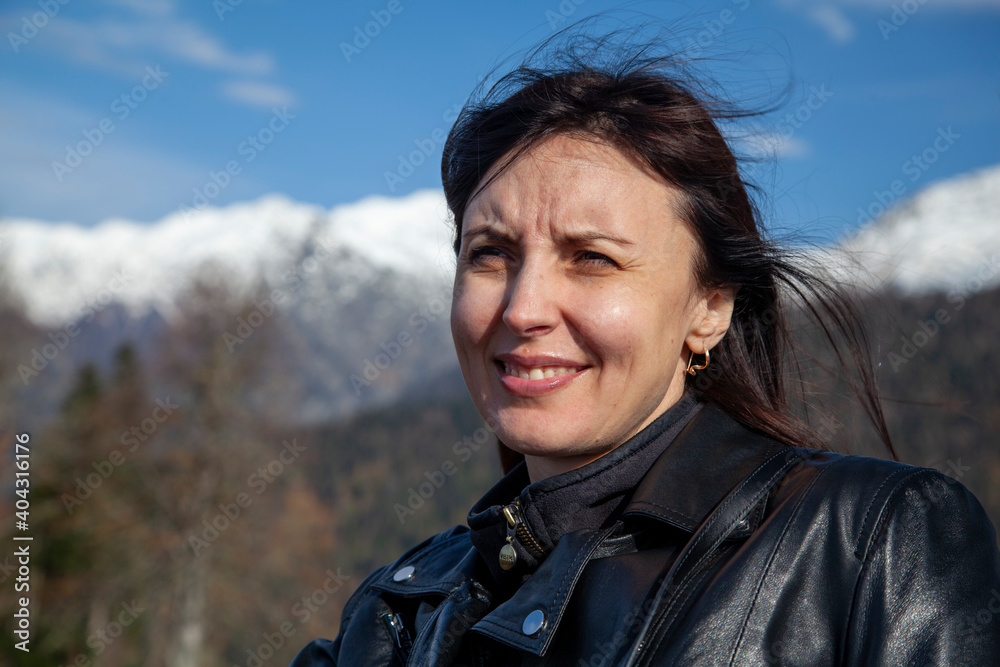 Krasnaya Polyana, Sochi, the mountains of the North Caucasus, snow-capped peaks against the background of autumn trees, girl looks at the mountains Krasnaya Polyana, Sochi, the mountains of the North Caucasus, snow-capped peaks against the background of autumn trees, girl looks at the mountains