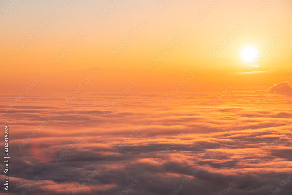Beautiful sunset sky above clouds, dramatic sunset sky. Nature background, aerial view.