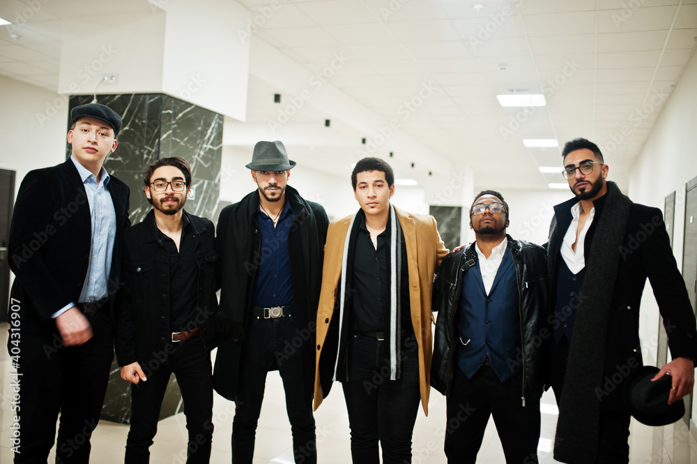Group of handsome retro well-dressed man gangsters indoor at hotel. Multiethnic male bachelor mafia. Group of handsome retro well-dressed man gangsters indoor at hotel. Multiethnic male bachelor mafia.