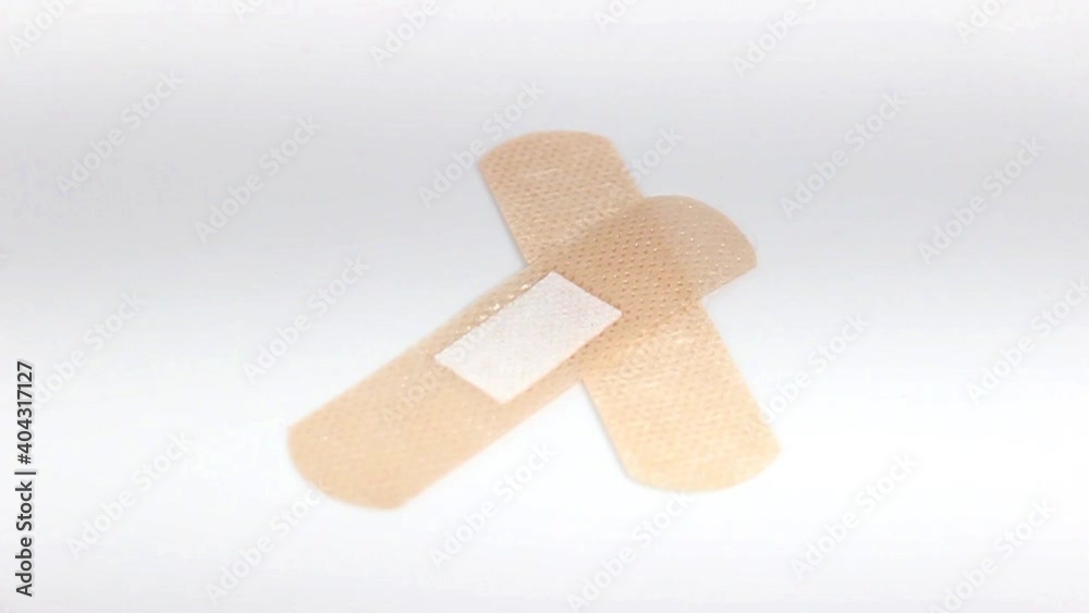 Sterile medical patch for wounds and calluses close-up. Turntable. Selective focus. Sterile medical patch for wounds and calluses close-up. Turntable. Selective focus.