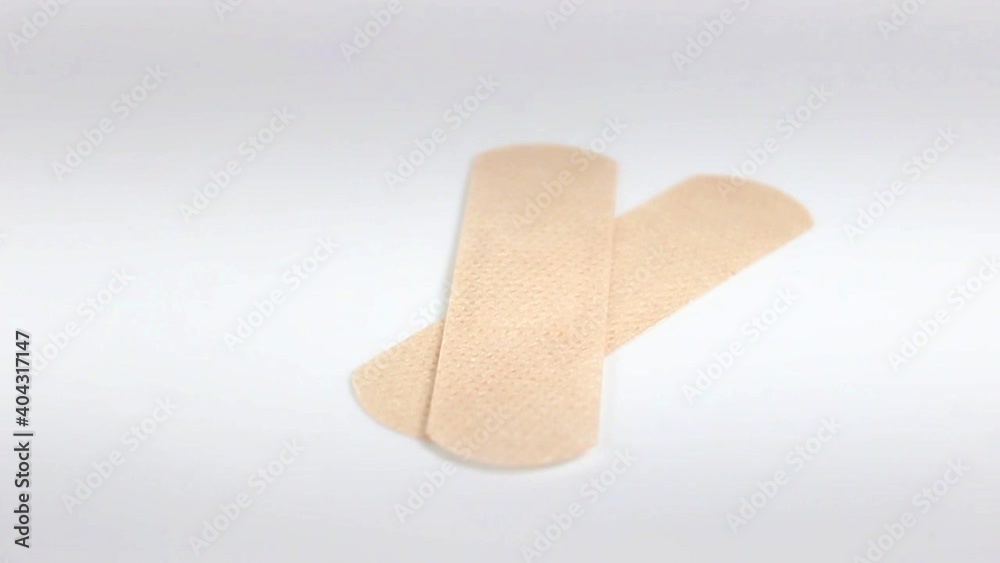Sterile medical patch for wounds and calluses close-up. Turntable. Selective focus. Sterile medical patch for wounds and calluses close-up. Turntable. Selective focus.