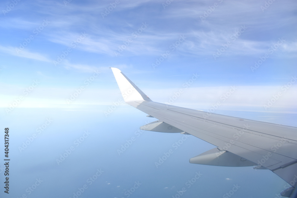 Fototapeta premium Beautiful horizon blue sky with white wing of airplane fiying on the air.