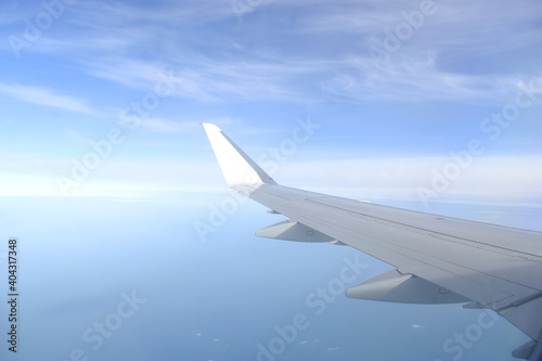 Beautiful horizon blue sky with white wing of airplane fiying on the air.