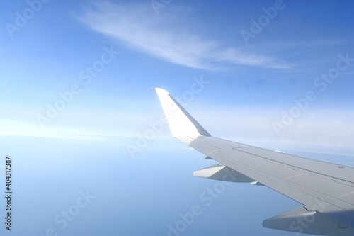 Beautiful horizon blue sky with white wing of airplane fiying on the air.