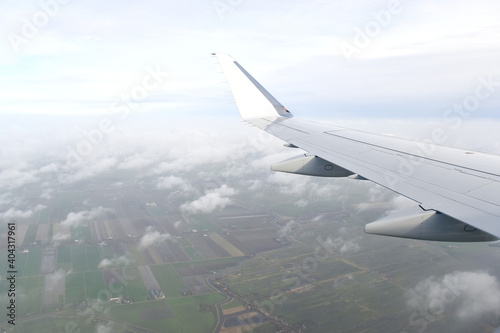 Beautiful white clouds floating high angle air, viewed from airplane window.