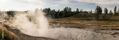 Wide shot of boiling mud caldron in yellowstone national park in america photo