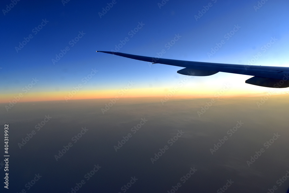 Silhouette of Airplan wing in twilight sky, with beautiful light from dramatic sunset, Romantic view from airplane window. Silhouette of Airplan wing in twilight sky, with beautiful light from dramatic sunset, Romantic view from airplane window.