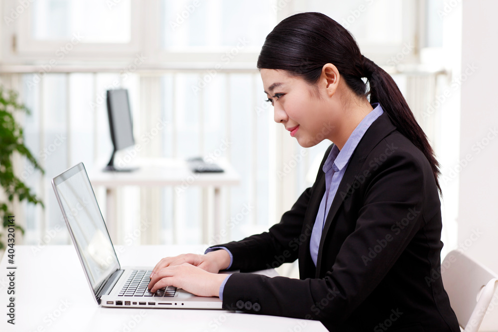A young Business woman using a laptop A young Business woman using a laptop