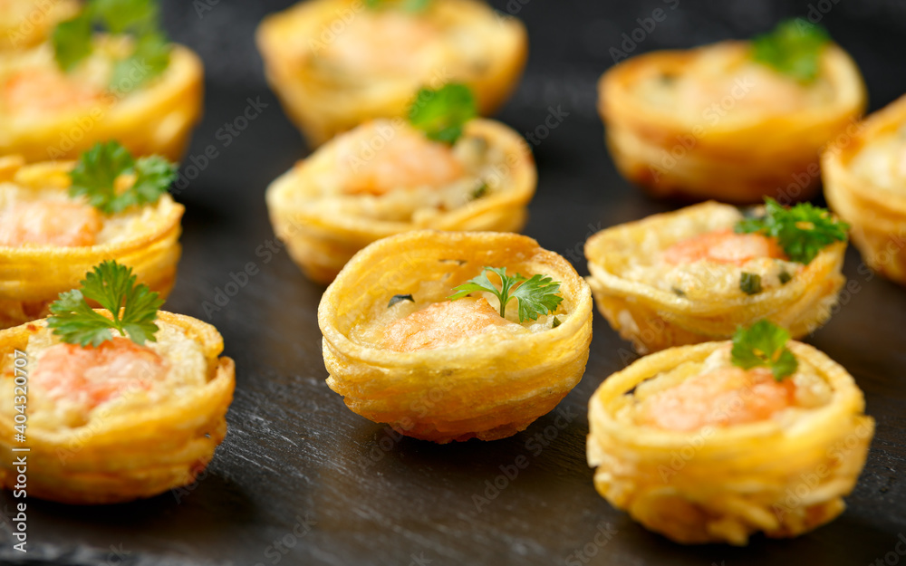 Mini party Fish Pie Food with prawn on rustic stone background Mini party Fish Pie Food with prawn on rustic stone background