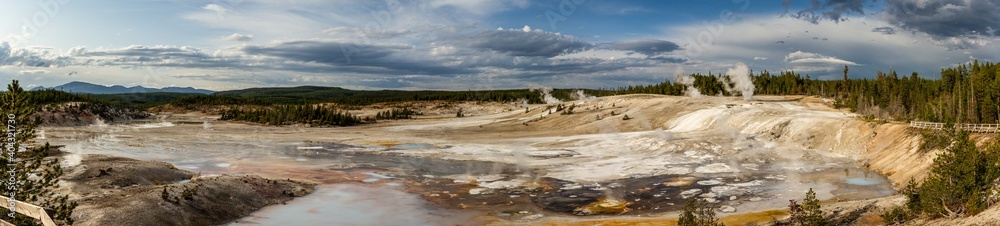 Panorama shot of hot colored water and steam of thermal nature in yellowstone national park in america