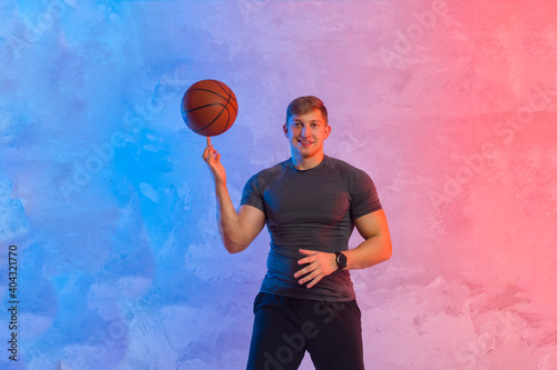 Basketball player balancing ball on one finger. Interactive coach concept