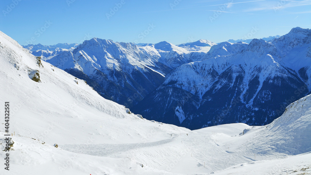 Panoramic view of the snowy mountains around Scuol ski resort in Switzerland.