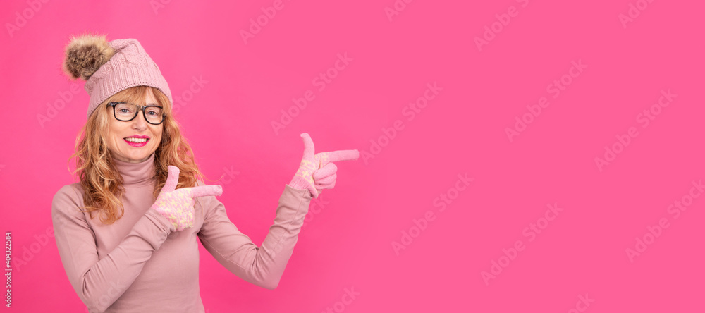 portrait of isolated adult or senior blonde woman pointing