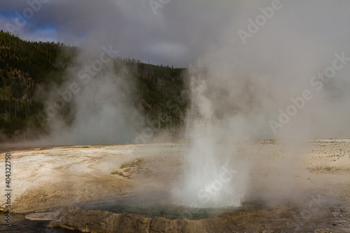 close up of hot blasting water from active gushing gayser in yellowstone national park in america