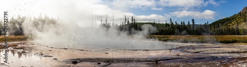 Panorama shot of steaming thermal lagoon with colored border in yellowstone national park in america